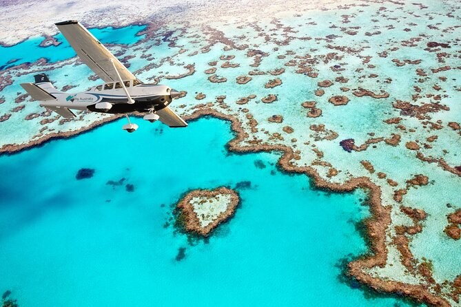 Heart Reef from the air, a small plane passing over the heart-shaped coral in turquoise water